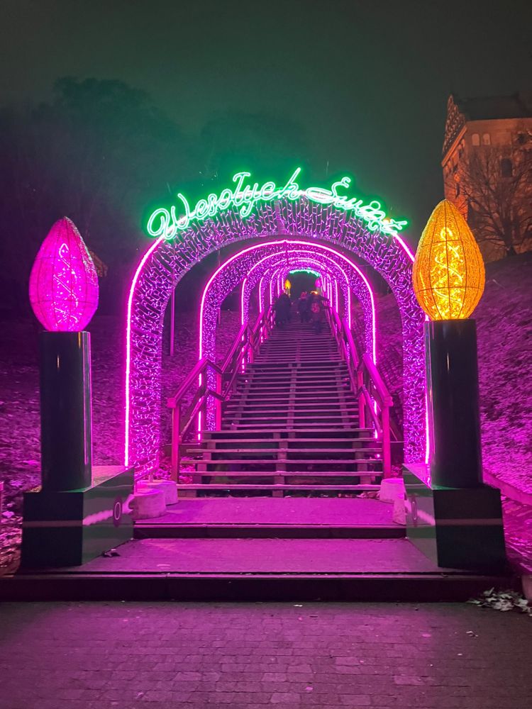 A tunnel of pink holiday lights over a staircase in Warsaw
